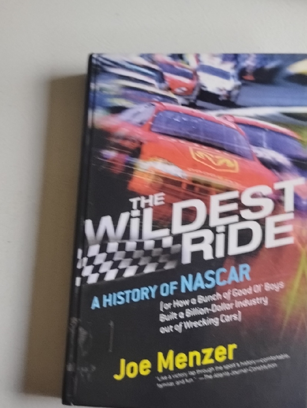The Wildest Ride: A History of NASCAR - Joe Menzer (Black/Red Cover)